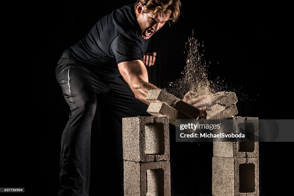 Male Fighter Breaking Bricks
