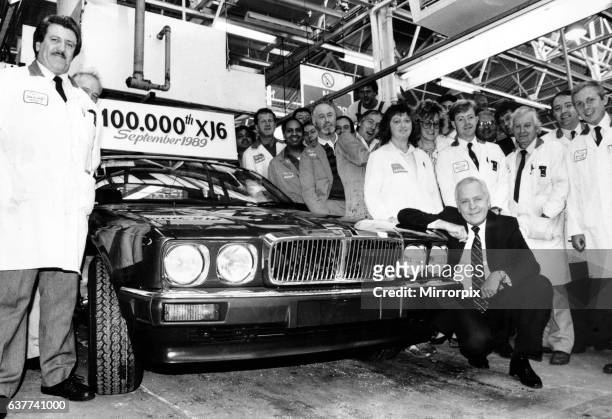 Jaguar Chairman and Chief Executive Sir John Egan at the front of the 100,000th XJ6 off the production line, surrounded by assembly worker. 11th...