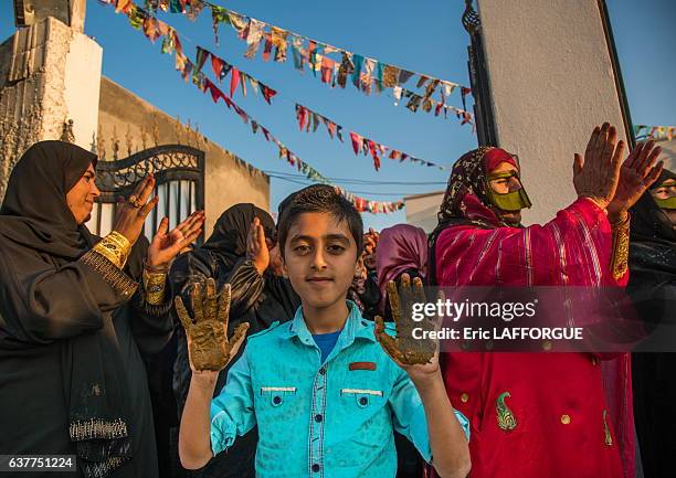 Young boy being covered with henna during a wedding ceremony on December 29, 2015 in Kushkenar, Hormozgan Province, Iran.