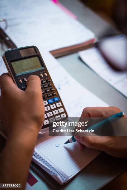 male student calculating and writing - mathematische funktion stock-fotos und bilder