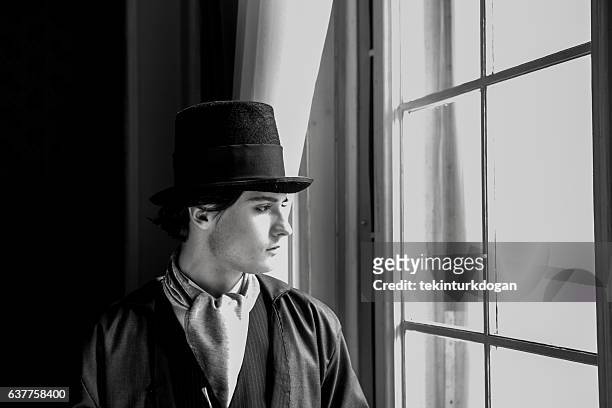 young ukranian male model posing with costume at lviv ukraine - man fedora room stock pictures, royalty-free photos & images