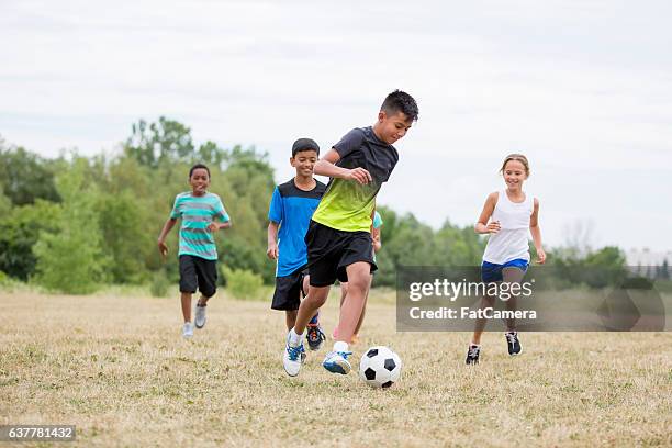 playing soccer at recess - indian football stock pictures, royalty-free photos & images