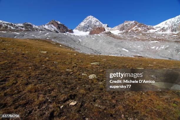 barren alpine tundra and snow-covered peaks in the italian alps - permafrost stock-fotos und bilder