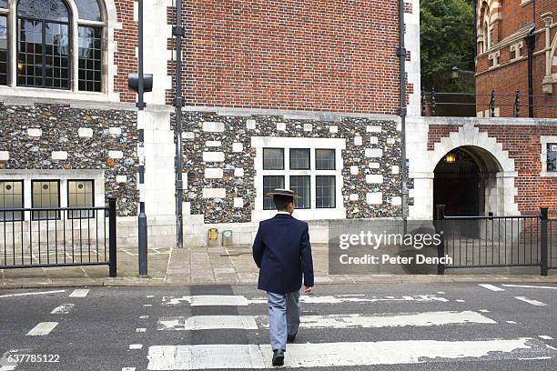 Pupil crosses the road outside Harrow School. Harrow School is an English independent school for boys situated in the town of Harrow, in north-west...