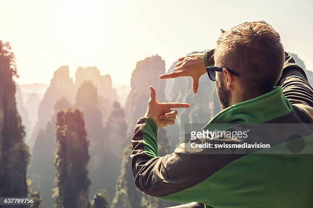 young hiker male framing landscape with fingers - quartz sandstone stock pictures, royalty-free photos & images