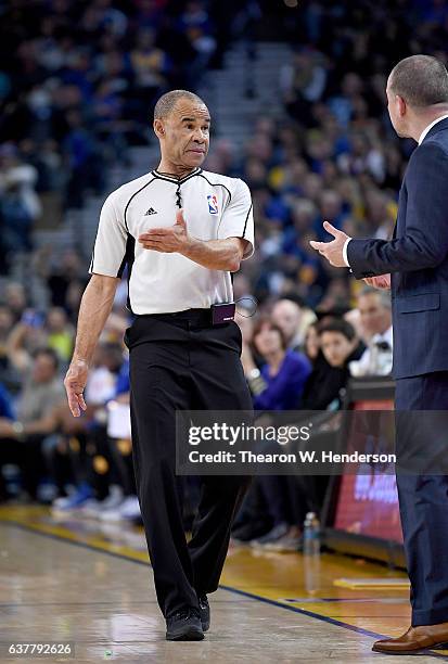 Referee Dan Crawford explains a call to head coach Michael Malone of the Denver Nuggets during an NBA basketball game against the Golden State...