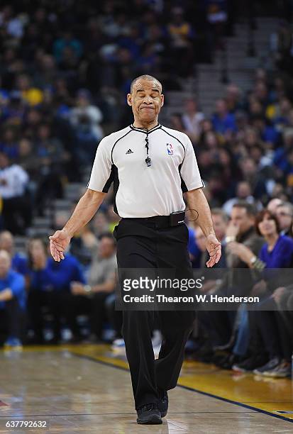 Referee Dan Crawford reacts after a call during an NBA basketball game between the Denver Nuggets and the Golden State Warriors at ORACLE Arena on...