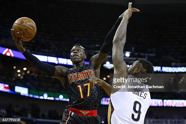 Dennis Schroder of the Atlanta Hawks shoots over Terrence Jones of the New Orleans Pelicans during the first half of a game at the Smoothie King...