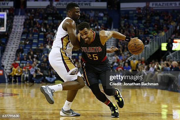 Thabo Sefolosha of the Atlanta Hawks drives against Terrence Jones of the New Orleans Pelicans during the first half of a game at the Smoothie King...