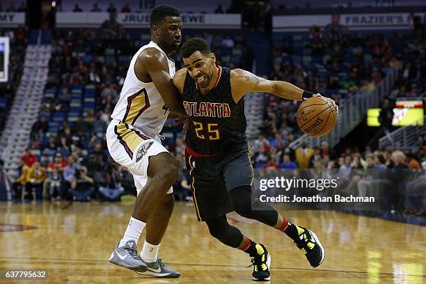 Thabo Sefolosha of the Atlanta Hawks drives against Terrence Jones of the New Orleans Pelicans during the first half of a game at the Smoothie King...