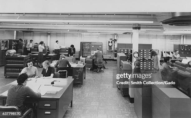 Female "human computers" perform mathmatics calculations for NASA/NACA in a typical computing area at the Langley Research Center, 1955. Image...