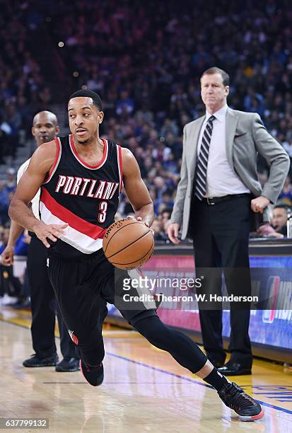McCollum of the Portland Trail Blazers dribbles the ball against the Golden State Warriors during an NBA basketball game at ORACLE Arena on January...