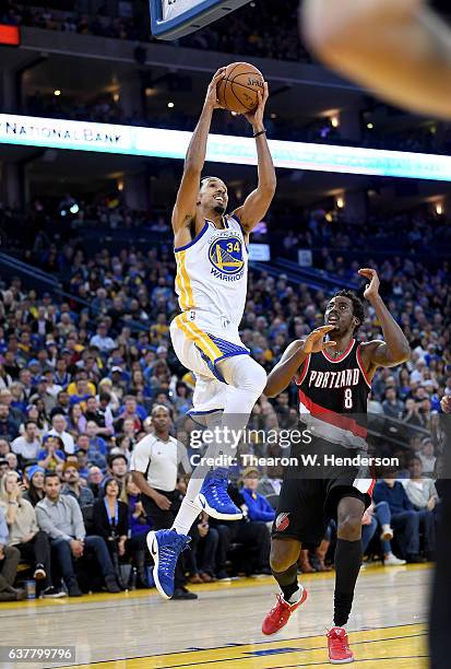 Shaun Livingston of the Golden State Warriors drives to the basket on Al-Farouq Aminu of the Portland Trail Blazers during an NBA basketball game at...