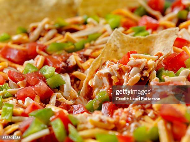 mexican layer dip with tortilla chips - layered dip stock pictures, royalty-free photos & images