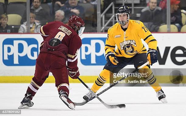 Brogan Rafferty of the Quinnipiac Bobcats defends against Austin Cangelosi of the Boston College Eagles in the first period during game one of the...