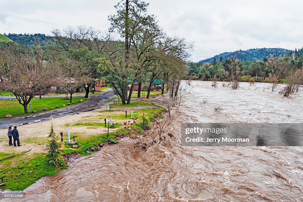 Two men at Coloma Campground watch American River High Waters