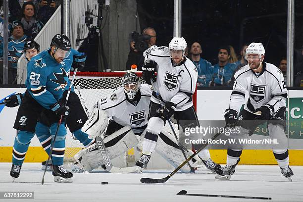 Peter Budaj, Anze Kopitar and Alec Martinez of the Los Angeles Kings defend the net against Joonas Donskoi of the San Jose Sharks at SAP Center on...