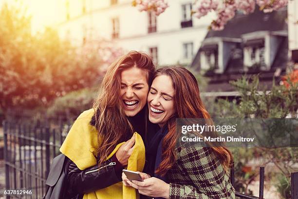 girls laughing at the street - gossip stockfoto's en -beelden