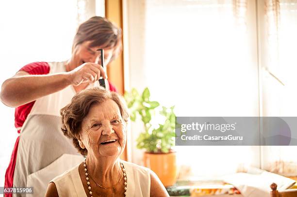 elderly home care service by a caregiver - dignity elderly stock pictures, royalty-free photos & images