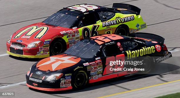 Ricky Rudd in the Robert Yates Racing Texaco-Havoline Ford dices with the Ford of Andy Houston during the NASCAR Winston Cup Talladega 500 at the...