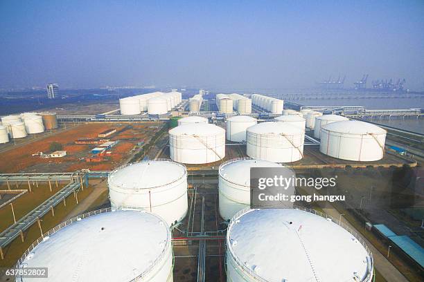 oil containers in modern refinery plant in blue sky - storage stock pictures, royalty-free photos & images