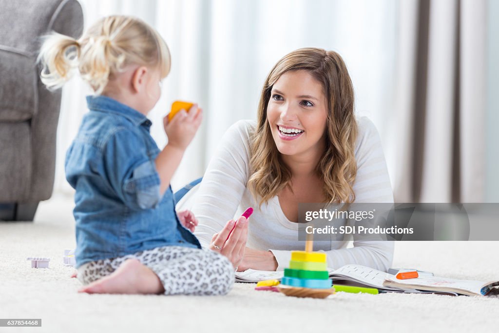 Pretty mother and her preschool age daughter play together