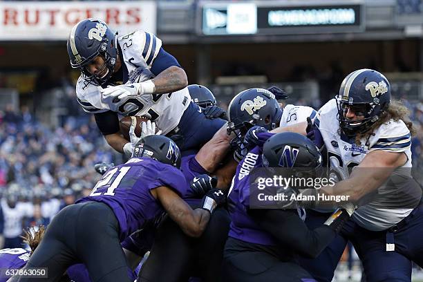 Running back James Conner of the Pittsburgh Panthers is stopped trying to score a touchdown against the Northwestern Wildcats during the New Era...