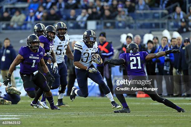 Rrunning back Qadree Ollison of the Pittsburgh Panthers in action past safety Kyle Queiro of the Northwestern Wildcats during the New Era Pinstripe...
