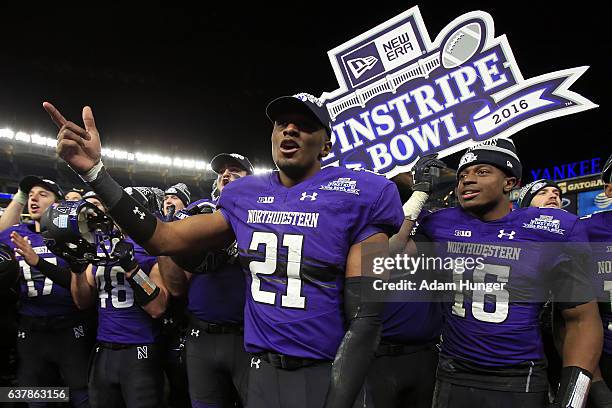Safety Kyle Queiro of the Northwestern Wildcats celebrates after defeating the Northwestern Wildcats in the New Era Pinstripe Bowl at Yankee Stadium...