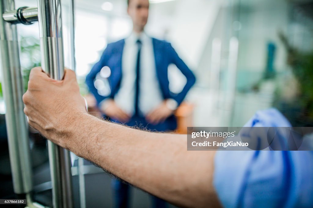 Hand opening door to businessman