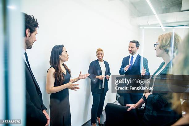group of colleagues having business meeting in office - performance collective stockfoto's en -beelden
