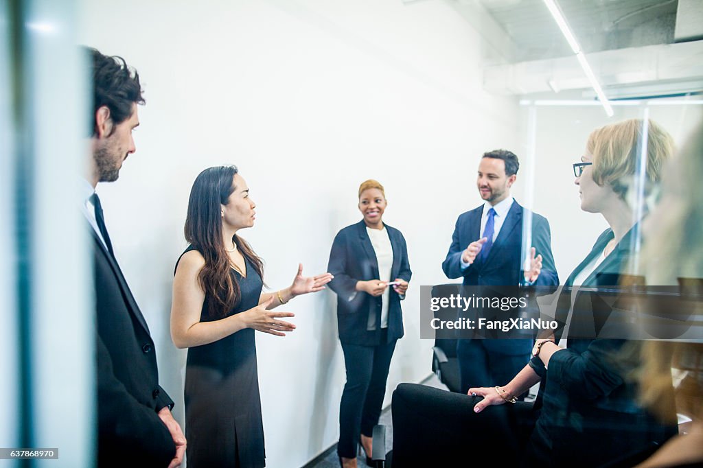 Group of colleagues having business meeting in office