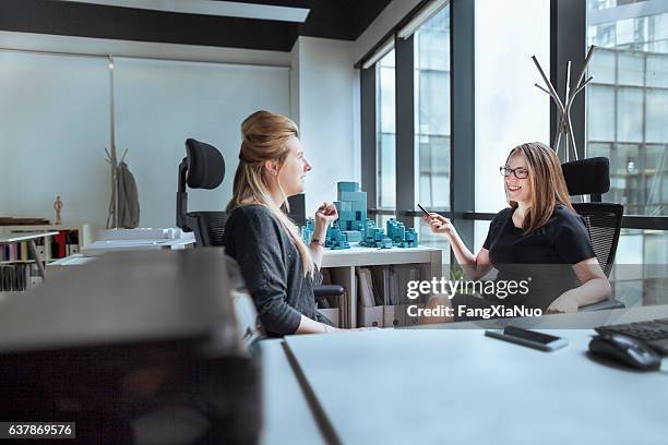 women talking together in design office - job centre stock pictures, royalty-free photos & images