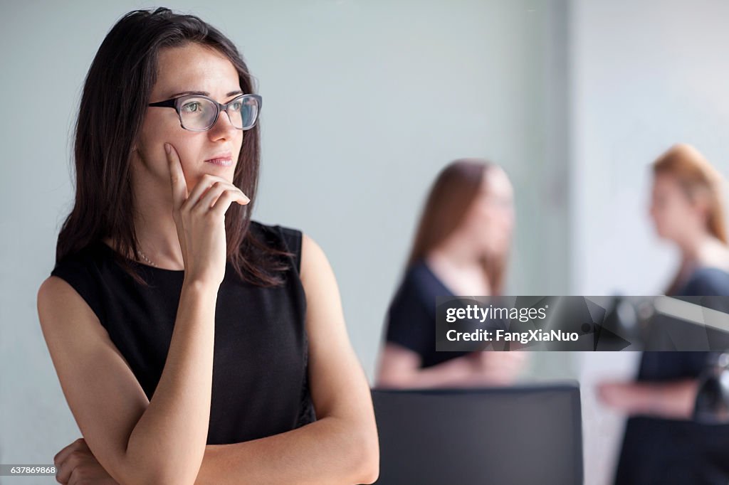 Young woman thinking in business office