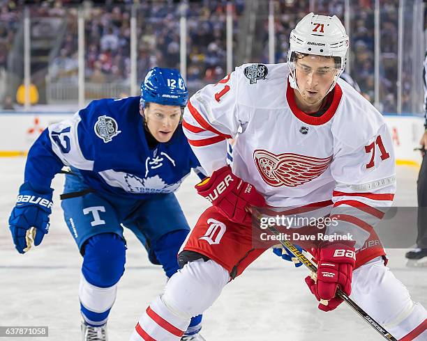 Dylan Larkin of the Detroit Red Wings controls the puck along the boards in front of Stephane Robidas of the Toronto Maple Leafs during the 2017...