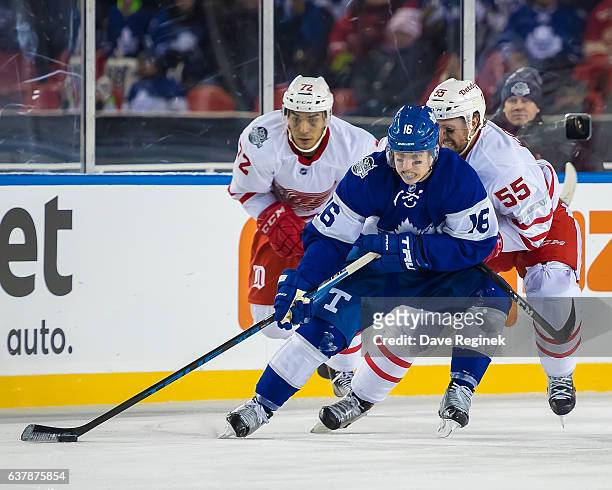 Mitch Marner of the Toronto Maple Leafs protects the puck from Niklas Kronwall of the Detroit Red Wings during the 2017 Scotiabank NHL Centennial...