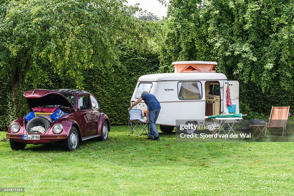 Volkswagen Beetle classic car with a caravan