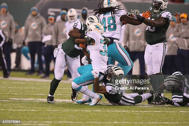 Linebacker David Harris and Safety Rontez Miles the New York Jets make a stop against the Miami Dolphins at MetLife Stadium on December 17, 2016 in...