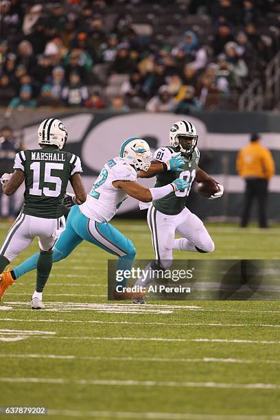 Wide Receiver Quincy Enunwa of the New York Jets has a long gain against the Miami Dolphins at MetLife Stadium on December 17, 2016 in East...