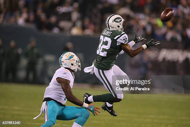 Cornerback Juston Burris of the New York Jets has his first career Interception against the Miami Dolphins at MetLife Stadium on December 17, 2016 in...