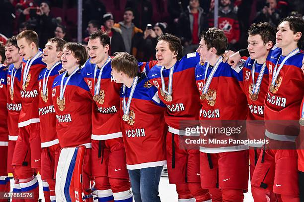 Team Russia lock arms after defeating Team Sweden and winning the bronze medal during the 2017 IIHF World Junior Championship at the Bell Centre on...