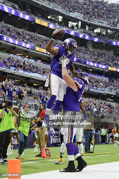 Jeremiah Sirles of the Minnesota Vikings congratulates Jarius Wright on a touchdown against the Chicago Bears during the game on January 1, 2017 at...