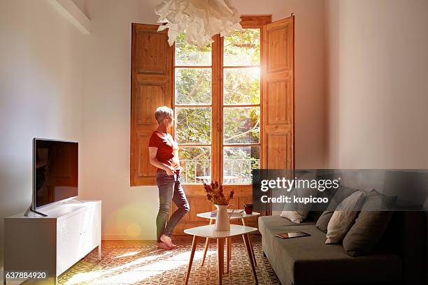 taking time to reflect on her day - sunny window stock pictures, royalty-free photos & images