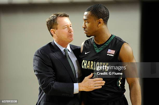 Head coach Mark Price of the Charlotte 49ers talks with Andrien White during the game against the Maryland Terrapins at Royal Farms Arena on December...