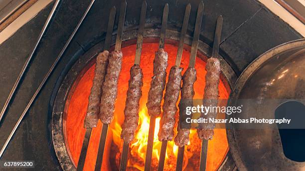 lamb tikka cooking on tandoor. - tandoor oven stock pictures, royalty-free photos & images