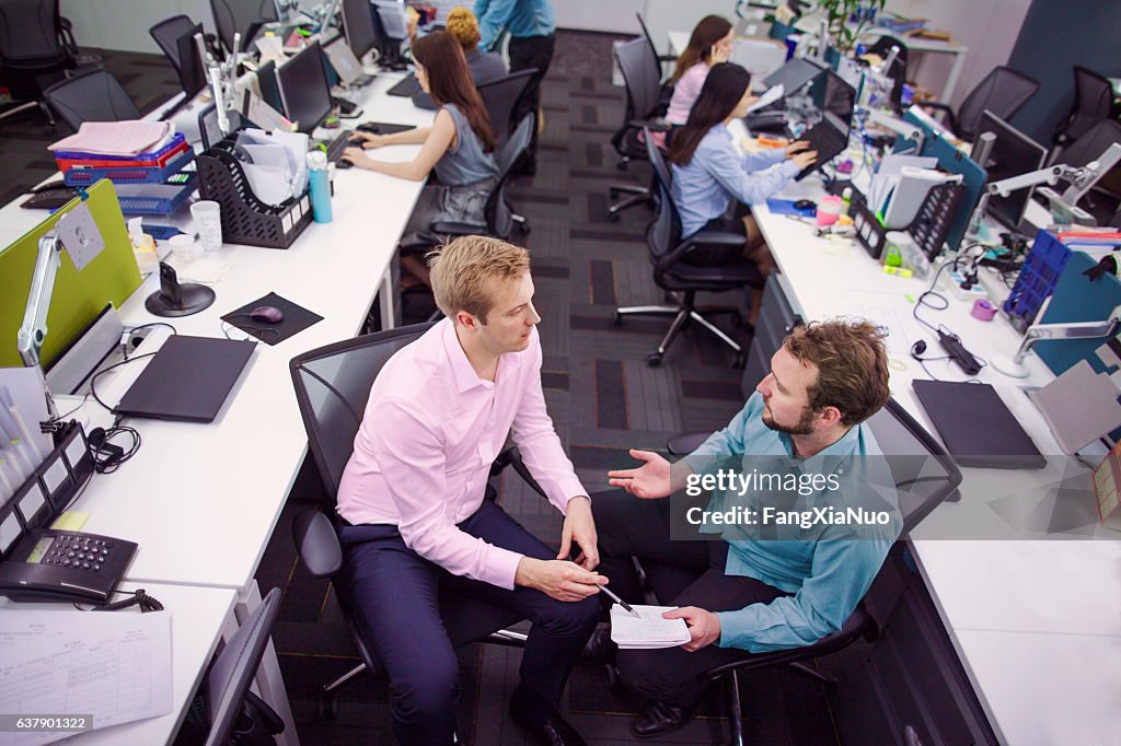 Overhead view of business colleagues talking in office