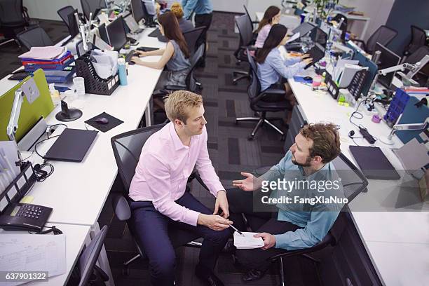 overhead view of business colleagues talking in office - people business meeting birdseye stock pictures, royalty-free photos & images
