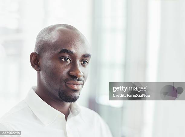 portrait of businessman in office - african american man day dreaming stock pictures, royalty-free photos & images