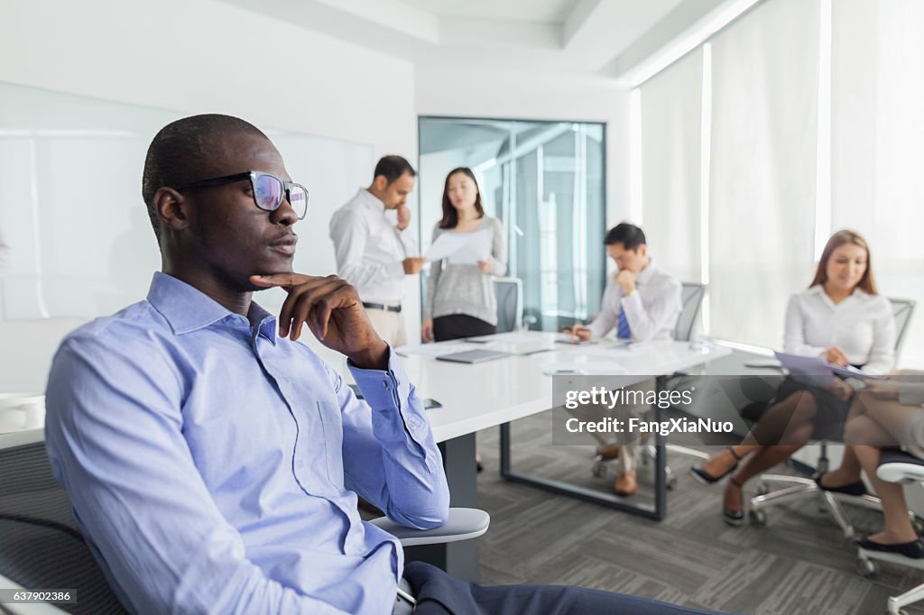 Businessman thinking during meeting in office