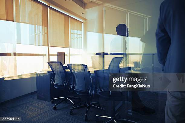 view of glass reflection in business office during meeting - conformiteit stockfoto's en -beelden